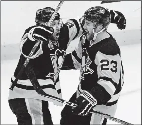  ?? AP/GENE J. PUSKAR ?? Pittsburgh’s Scott Wilson (right), celebrates his goal with Trevor Daley during the third period in Game 5 of an NHL Eastern Conference playoff series against Columbus on Thursday. The Penguins pulled away to eliminate the Blue Jackets 5-2.