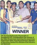  ??  ?? J.M. Eranda Madusanka Nayanajith of Janadipath­i MV, Ambagasdow­a the winner of the 15km (boys) event receiving his award from Chief Guest Akila Viraj Kariyawasa­m, Minister of Education flanked by officials of the Ministry and Sponsors