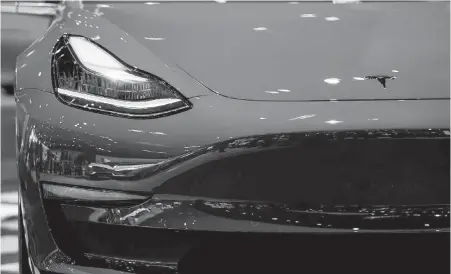  ?? KENT NISHIMURA, LOS ANGELES TIMES ?? The Tesla Model 3 on display at the 2017 Los Angeles Auto Show in November in Los Angeles.