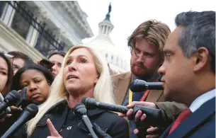  ?? ALEX WONG/GETTY ?? Rep. Marjorie Taylor Greene threatens Friday on the U.S. Capitol steps to oust House Speaker Mike Johnson.