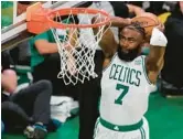  ?? MICHAEL DWYER/AP ?? Celtics’ Jaylen Brown dunks the ball against the Warriors during the second quarter of Game 3 on Wednesday in Boston.