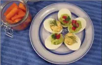  ?? THE ASSOCIATED PRESS ?? Stuffed eggs with tuna, topped with dill, and guacamole, topped with tomatoes.