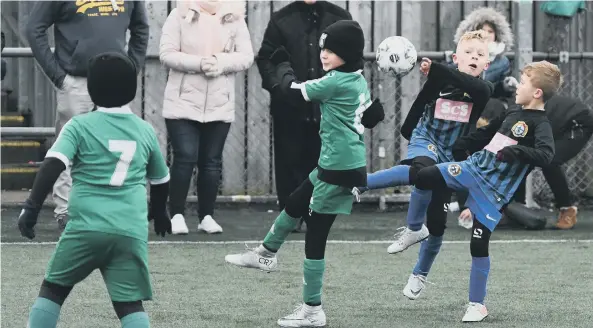  ??  ?? Easington Colliery Whites Under-7s (green) in action against Seaham Coast (black/blue).