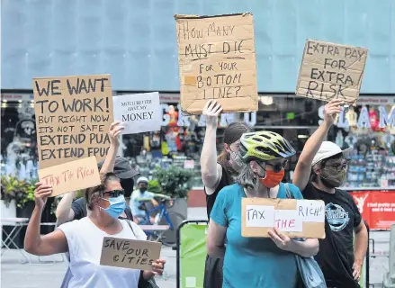  ?? AFP ?? Protesters rally demanding economic relief during the coronaviru­s pandemic, at Time Square in New York City on Aug 5, 2020.