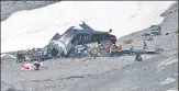  ?? AFP ?? Rescue personnel gather around the wreckage of a Junkers JU52 aircraft after the aeroplane crashed into Piz Segnas in eastern Switzerlan­d on Saturday.