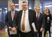  ?? J. SCOTT APPLEWHITE / ASSOCIATED PRESS ?? Sen. Jon Tester, D-Mont., flanked by Sen. John Boozman, R-Ark. (left) and Sen. James Lankford, R-Okla., arrive with other lawmakers for a procedural vote Tuesday.