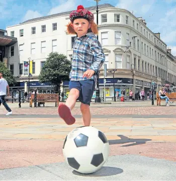  ??  ?? HAVING A BALL: Harry Reid, 5, from Dundee, hopes to watch today’s historic clash.