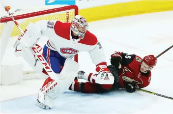  ?? ROSS D. FRaNKLIN/THE ASSOCIATED PRESS ?? Canadiens goaltender Carey Price jumps out of the way as Arizona Coyotes right winger Josh Archibald slides into the goal during the second period of Thursday’s game in Glendale, Ariz. The Canadiens defeated the Coyotes 2-1 as Price picked up his 300th victory.
