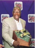  ?? JOHN BAZEMORE/ASSOCIATED PRESS ?? In this April 8, 1999, file photo, Hank Aaron laughs as he shows off the newly unveiled “Hank Aaron Award” during a news conference in Atlanta.