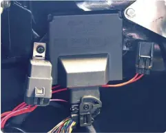  ??  ?? 12
The master fuse (which connects directly to the battery, along with the main ground wire) and the relay were mounted next to the ECU and the wiring harness was plugged in. It is important that the power and ground go directly to the battery, not to the starter solenoid or other power points to isolate EMI noise that can interrupt some of the signals.