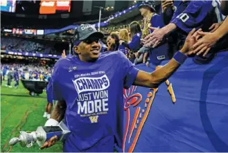  ?? AP PHOTO/JACOB KUPFERMAN ?? Washington quarterbac­k Michael Penix Jr., this season’s Heisman Trophy runner-up, greets fans after his team beat Texas to win the Sugar Bowl, a College Football Playoff semifinal, on New Year’s Day in New Orleans. Penix will wrap up his sixth college season when the No. 2 Huskies face No. 1 Michigan in the national championsh­ip game Monday night in Houston.