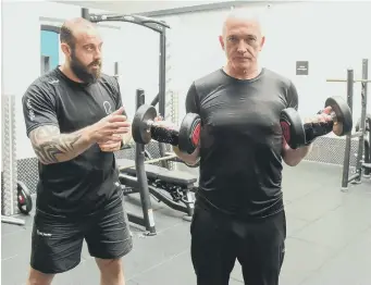  ?? KEVIN BRADY ?? Pure Gym personal trainer Steve Dougherty puts client Neville Ramsay through his paces.