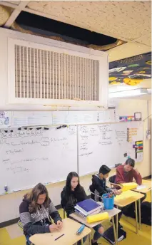  ?? GREG SORBER/JOURNAL ?? Several classrooms at Grant Middle School have water damage to the ceiling such as in this eighth-grade Gifted Language Arts class.