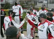  ?? CURTIS COMPTON — THE ASSOCIATED PRESS ?? Ryan Blaney, left, gives his pit crew fist-bumps after winning Sunday’s Cup Series at Atlanta Motor Speedway.