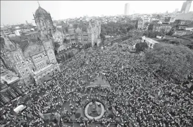  ?? SHAILESH ANDRADE / REUTERS ?? People gather to take part in a protest, organized by Maharashtr­a state’s Maratha community, to press their demands for reserved quotas in government jobs and college places for students, in Mumbai, India, on Wednesday.