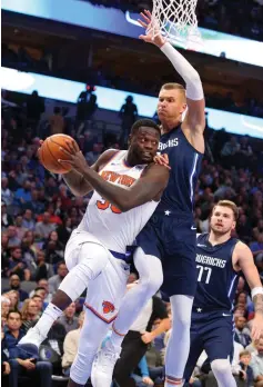  ?? AP Photo/Richard W. Rodriguez ?? ■ New York Knicks forward Julius Randle (30) looks to pass the ball under pressure from Dallas Mavericks forward Kristaps Porzingis (6) on Friday in Dallas.