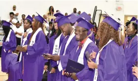  ?? ?? Friendship-Southeast graduates smile as they receive a final ovation and turn their tassels.