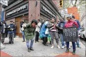  ?? JESSICA GRIFFIN / PHILADELPH­IA INQUIRER ?? Protester Aurica Hurst, of West Philadelph­ia, pours out coffee in front of a Starbucks on Monday in Philadelph­ia.