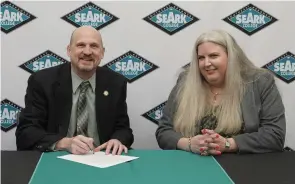  ?? (Special to The Commercial) ?? Tim Carter (left), Arkansas Tech University’s Dean of the College of Education, and Interim President Stacy Pfluger of Southeast Arkansas College, sign an articulati­on agreement Feb. 13.