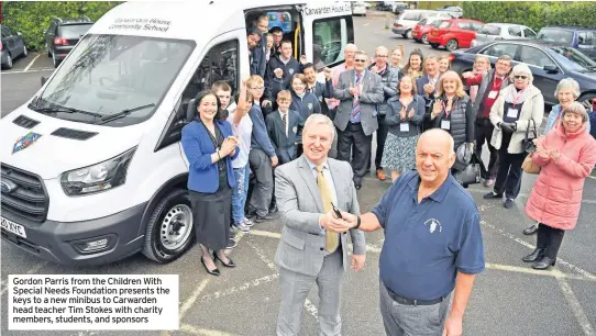  ??  ?? Gordon Parris from the Children With Special Needs Foundation presents the keys to a new minibus to Carwarden head teacher Tim Stokes with charity members, students, and sponsors