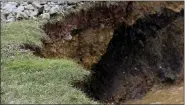  ?? BEN HASTY — MEDIANEWS GROUP ?? The hole is widening from erosion along Old Route 100 in Washington Township Monday afternoon January 11, 2021, where a crew from the DEP was working on filling it in with rocks. The hole is above the site of a 19th century abandoned iron ore mine.