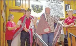  ?? Julia McKinney ?? Lisa Wilder, from left, drapes a Quilt of Valor over Bruce Henderson as Brenda Park, Rufus Wyatt and Patty Defoor look on. Henderson and Wyatt were both presented quilts this week in honor of their military service.