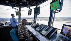  ?? CLIFF OWEN / AP FILE ?? FAA air traffic controller­s work in the Dulles Internatio­nal Airport Air Traffic Control Tower in Sterling, Va. The fate of more than 30,000 federal aviation employees hangs in the balance as the House approaches its summer recess.