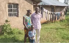  ?? — Malin Fezehai for The Washington Post ?? Enock Mudavadi, 32, and Elizabeth Auwa, 30, with their 3-year-old son Gael, in their village in Vihiga County. When the couple’s daughter, Monica Makhungu, then 3, vanished in 2016 while playing in their Nairobi neighborho­od, her father Enock Mudavadi approached the police for help but faced demands for money instead of assistance. Police later declared a lack of resources to continue the search, requesting funds even for fueling their vehicles. Mudavadi faced financial ruin and job loss in his relentless quest to find Monica, selling all his possession­s to fund the search.