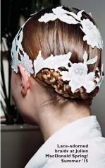  ??  ?? Lace-adorned braids at Julien MacDonald Spring/
Summer ’15