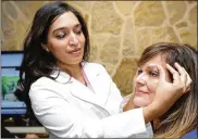  ??  ?? Dr. Amina Husain, with Premier Eye Surgeons, warns residents against staring at the sun.