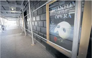  ??  ?? A poster for The Phantom Of The Opera outside the shuttered Majestic Theatre in New York.