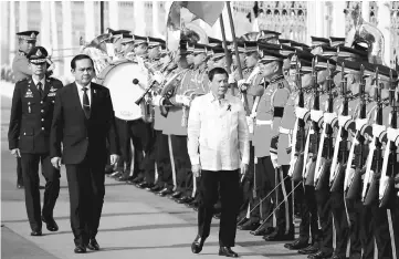  ??  ?? Prayuth welcomes Philippine President Rodrigo Duterte (right) at the Government House in Bangkok. Duterte is on a two-day official visit to Thailand.— Reuters photo