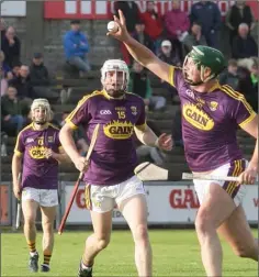  ??  ?? It’s all Wexford here as Joe Coleman’s catch is watched approvingl­y by team-mates Darren Codd (15) and Cathal Dunbar (background).