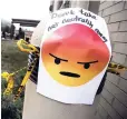  ?? AP ?? A sign with an emoji posted outside the Federal Communicat­ions Commission reads: ‘Don’t take net neutrality away’.