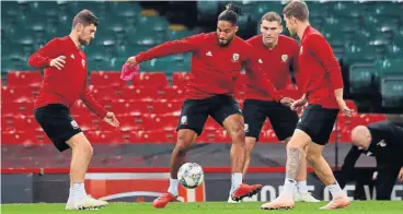  ?? /Reuters ?? Moving along: Wales footballer­s, from left Ashley Williams, Ben Davies, Aaron Ramsey and Sam Vokes, at training ahead of the friendly against Spain on Thursday. Vokes remains confident of victory and says Wales have a lot of players playing at top level.