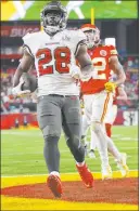  ?? Ben Liebenberg The Associated Press ?? Leonard Fournette finishes his 27-yard TD run in the second quarter of the Buccaneers’ Super Bowl triumph over the Chiefs on Sunday.