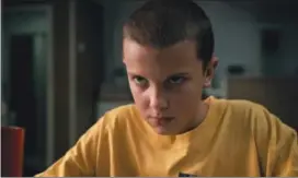  ?? NETFLIX VIA AP ?? This image released by Netflix shows Millie Bobby Brown in a scene from, “Stranger Things.” Brown portrays Eleven, who can move things with her mind and is the fascinatin­g secret friend of a group of pre-teen boys in the fictional town of Hawkins, Ind.