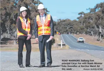  ?? Picture: ALISON WYND ?? ROAD WARRIORS: Balliang East principal Caryn Fox with Roads Minister Luke Donnellan at Bacchus Marsh Rd this week.