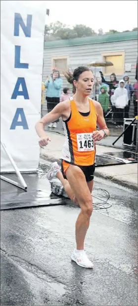  ?? — Telegram file photo by Keith Gosse ?? Kate Bazeley won her second straight Tely 10 female championsh­ip on a rainy course a year ago. She says she will chase a third title on Sunday even though illness has kept her from training and competing for much of this running season.