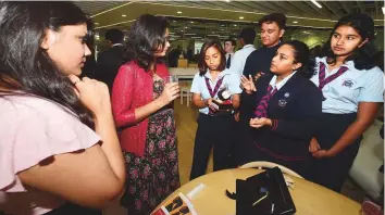  ?? Atiq Ur Rehman/Gulf News ?? Grade 11 students of Winchester School Jebel Ali demonstrat­e a wearable device catering to those who have anxiety attacks at GEMS Xhibit 2018 in Dubai yesterday.Right: Grade 10 students demonstrat­e Merculite, an electricit­y-generating device.