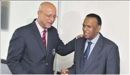  ??  ?? Cricket West Indies President Ricky Skerritt (left) speaks to Jamaica Cricket Associatio­n President Billy Heaven ahead of a meeting at Terra Nova All-suite Hotel in Jamaica on Wednesday.