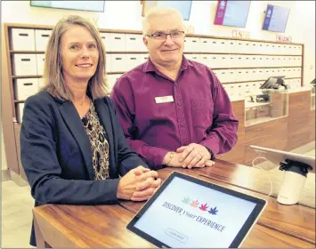  ?? CARL ALLEN ?? NSLC communicat­ions advisor Beverley Ware with Yarmouth NSLC manager Mike Wilson at the new cannabis shop in the Yarmouth store.