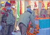  ?? —Sajad Hameed ?? A senior officer pays his last respect to J&K Police SPO Mohammad Altaf in Srinagar on Friday.