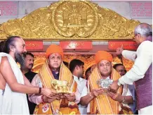  ?? PHOTO: PTI ?? Gujarat Chief Minister Vijay Rupani (left) with Deputy Chief Minister Nitinbhai Patel at Jagannath Temple in Ahmedabad on Friday