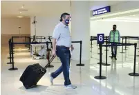  ?? (Reuters) ?? SEN. TED CRUZ wheels his luggage through Mexico’s Cancun Internatio­nal Airport before boarding his plane back to the US last Thursday.