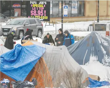  ?? PETER J. THOMPSON / NATIONAL POST ?? A homeless encampment in Kitchener, Ont. “Homeless shelters are miserable places.
A man’s home is his castle, even it’s made of canvas,” columnist Chris Selley says.