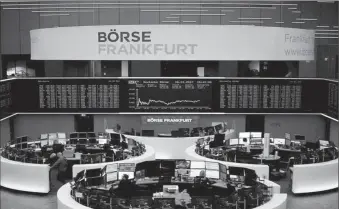  ?? -AFP ?? Traders work on the floor of Frankfurt Stock Exchange in Germany.