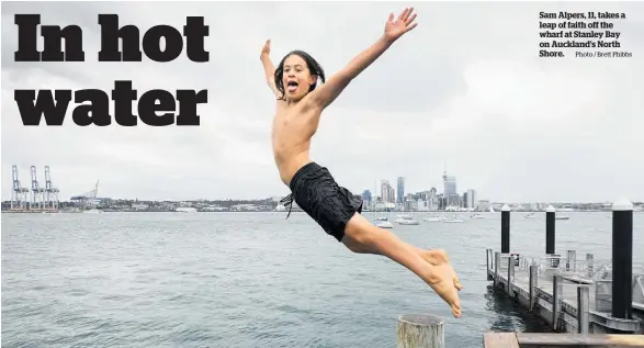  ?? Photo / Brett Phibbs ?? Sam Alpers, 11, takes a leap of faith off the wharf at Stanley Bay on Auckland’s North Shore.