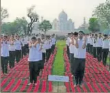  ?? HT PHOTO ?? People perform yoga with Taj Mahal in the backdrop in Agra on Wednesday.