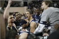  ?? JESSICA HILL — THE ASSOCIATED PRESS ?? Yale players celebrate their Ivy League championsh­ip win over Harvard last weekend. The Bulldogs face LSU in the first round of the NCAA Tournament.